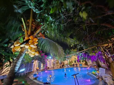 a large swimming pool with a bunch of palm trees at OASIS Phuket Airport in Nai Yang Beach