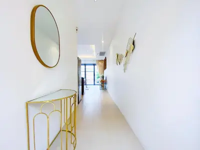 a hallway with a mirror and a gold console at Beautiful 1br Plunge Pool Villa Walk To Bangtao Beach in Ban Thalat Choeng Thale