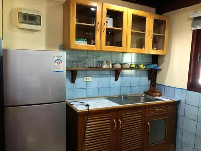 a kitchen with a refrigerator and a sink at Lam Sai village hotel Koh Yao Noi in Ko Yao Noi