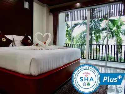 a hotel room with a bed with a heart on it at Vivi Boutique Room Hotel SHA Plus in Rawai Beach