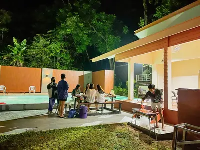 a group of people standing outside of a house at Holiday Resort - SHA Plus in Ko Yao Noi