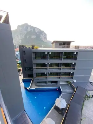 a building with a swimming pool in front of it at Aonang Dugong-SHA Extra Plus in Ao Nang Beach