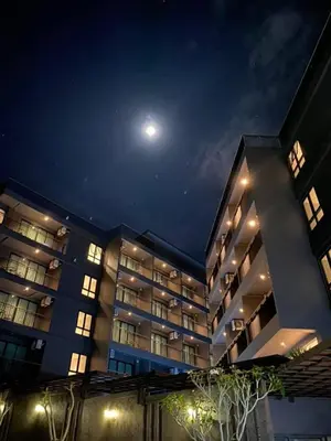 a large building at night with the moon in the sky at Aonang Dugong-SHA Extra Plus in Ao Nang Beach