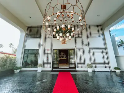 a large lobby with a red carpet and a chandelier at Ratri Hotel Phuket Old Town in Phuket Town