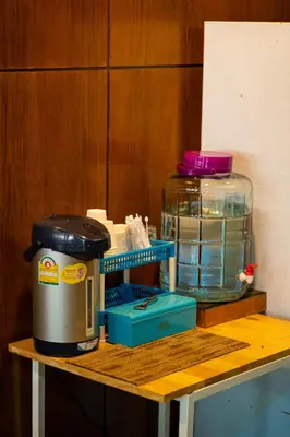 a table with a coffee maker and a jar on it at Mayfa Hotel - SHA extra plus in Phuket Town