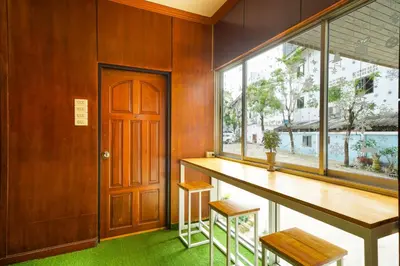 a room with a table and a large window at Mayfa Hotel - SHA extra plus in Phuket Town