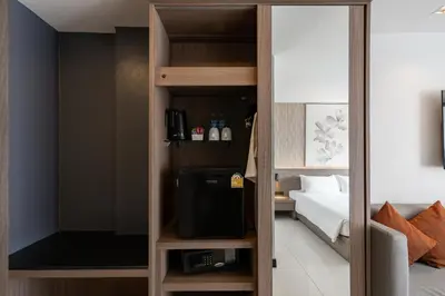 a room with a tv and a bed in a room at Citrus Patong Hotel by Compass Hospitality in Patong Beach