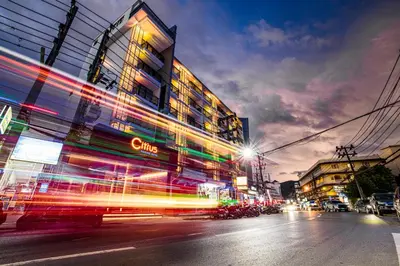 a city street at night with buildings and cars at Citrus Patong Hotel by Compass Hospitality in Patong Beach