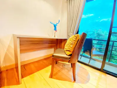 a room with a desk and a chair and a window at The Nakara Town in Ban Rangeng
