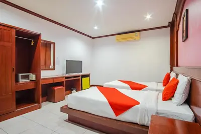a bedroom with a bed and a television in it at Art Mansion Patong Hotel in Patong Beach