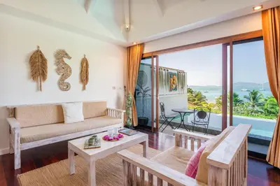 a living room with a couch and a table at Soul Villas - Beachfront Private Pool Villas, Phuket Nature Retreat in Panwa Beach