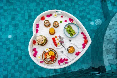 a plate of food on a table in a pool at Soul Villas - Beachfront Private Pool Villas, Phuket Nature Retreat in Panwa Beach