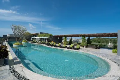 a large swimming pool with chairs on a building at 2-Bedroom Apartment at Calypso Garden Residences in Rawai Beach