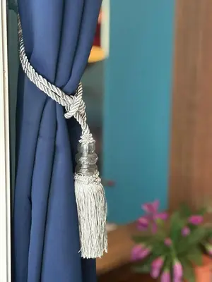 a rope tied to a blue curtain at San Antonio Beach Guesthouse & Restaurant in Kata Beach