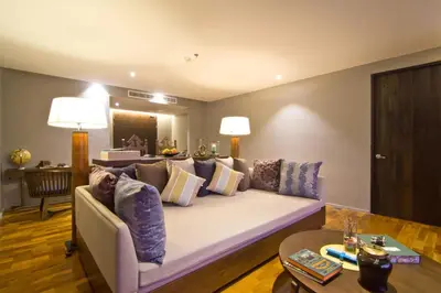 a living room with a couch with pillows at Le Coral Resort in Natai Beach