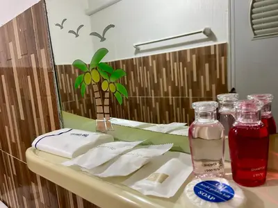 a bathroom counter with a sink with a mirror at Phi Phi Ba Kao Bay Resort in Phi Phi Don