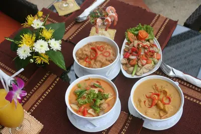 a table with four bowls of food on it at Palmview Resort in Patong Beach