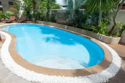 a swimming pool in a resort with a blue at Palmview Resort in Patong Beach
