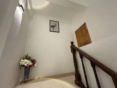 a staircase with a vase of flowers on the wall at Inn Dulgence in Patong Beach