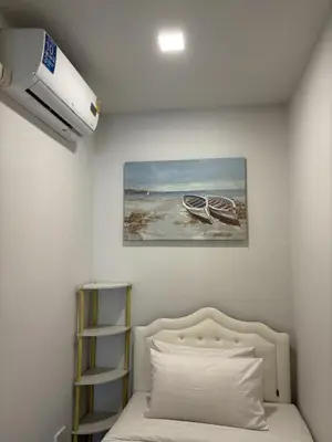 a bedroom with a bed and a painting of a boat at Inn Dulgence in Patong Beach