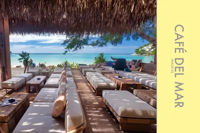 a row of chaise lounges on the beach at Pool Access 2 BDR Stylish Condo in Kamala Beach