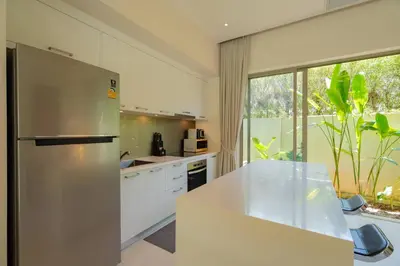 a large kitchen with a stainless steel refrigerator at 3BR Villa with Private Pool in Trichada Sky at Bangtao Beach in Bang Tao Beach