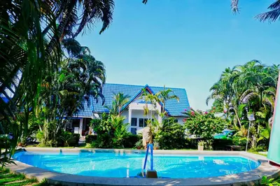 a swimming pool in front of a resort at Kingsacre in Nai Yang Beach
