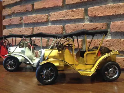 a yellow electric car parked next to a brick wall at Dfeel House in Patong Beach