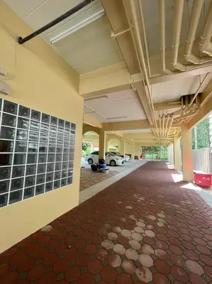 an empty hallway of a building with a parking lot at บ้านบัว เมืองใหม่ Baanbua Muangmai in Thalang