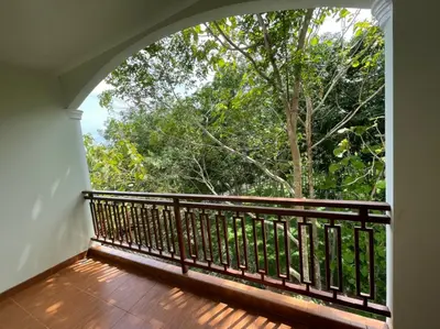 a balcony with a view of a tree at บ้านบัว เมืองใหม่ Baanbua Muangmai in Thalang