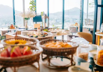 a buffet of food on tables in a restaurant at Hilltop Wellness Resort Phuket in Phuket Town