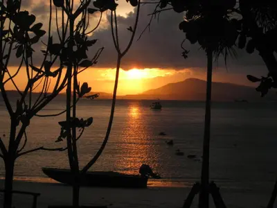 a sunset over the ocean with boats in the water at Davina Beach Homes in Panwa Beach