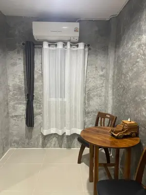 a room with a table and a window with a heater at MONDEE House @The Airport in Thalang