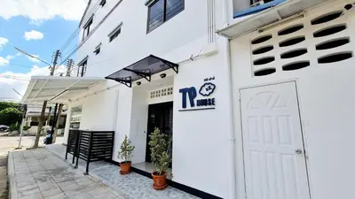 a white building with a white door and a sign on it at TP House@Naka in Phuket Town