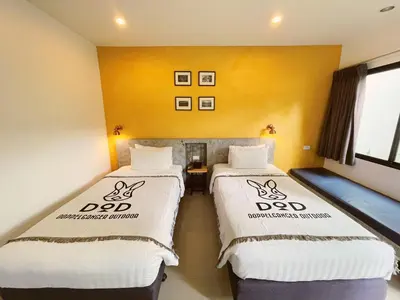 two beds in a room with yellow walls at Ideo Phuket Hotel - Naiyang Beach in Nai Yang Beach