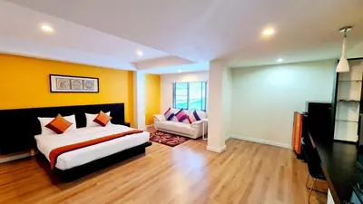 a bedroom with a bed and a couch in it at TP House at town in Phuket Town