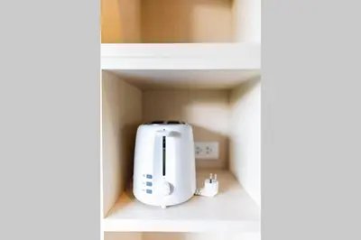 a white appliance is sitting on a shelf at Honeybee Pool Villa Smooth as Silk in Ao Nang Beach