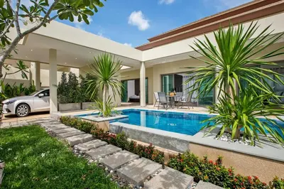 a house with a swimming pool in front of a house at Shanti Villas x MonthStayZ Thailand in Rawai Beach