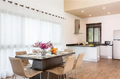 a kitchen and dining room with a table and chairs at Shanti Villas x MonthStayZ Thailand in Rawai Beach