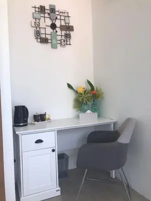 a white desk with a chair and a plant at Villa MAI MEE PAN HA 3 bedrooms in Nai Yang Beach