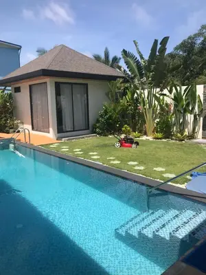 a swimming pool in front of a house at Villa MAI MEE PAN HA 3 bedrooms in Nai Yang Beach