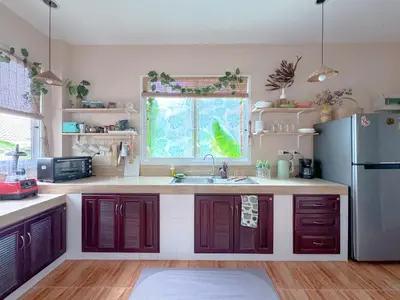 a kitchen with a sink and a refrigerator at Sea Dreamer Beachfront Apartments in Phuket Town