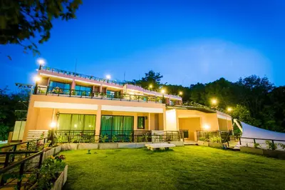 a building with a lawn in front of it at night at Studio apartments on a hill in Kathu