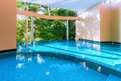 a swimming pool in a building with a large window at Studio apartments on a hill in Kathu
