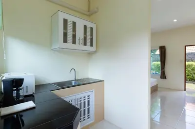 a kitchen with a sink and a microwave at RAWAÏ Bedroom and kitchen in Rawai Beach