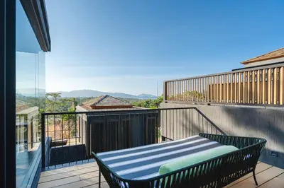 a balcony with a bench on the side of a building at AKRA Collection Layan - Hideaway Villas in Layan Beach