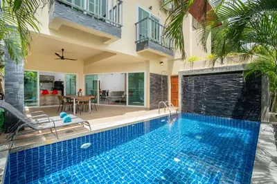 a swimming pool in front of a house at Sabai Villas, 7 min drive from Naiharn & Rawai, Private pool, Four villas available in Rawai Beach