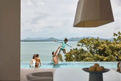 a group of people playing in the water at a resort at COMO Point Yamu, Phuket in Ban Pa Khlok