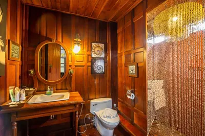 a bathroom with a toilet and a sink and a mirror at Royal Thai Villa Phuket - SHA Extra Plus in Rawai Beach