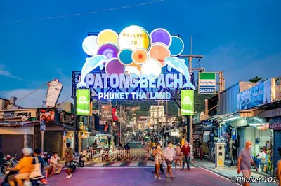 a group of people crossing a busy city street at TJ Patong Hotel - Otop Shopping Paradise in Patong Beach